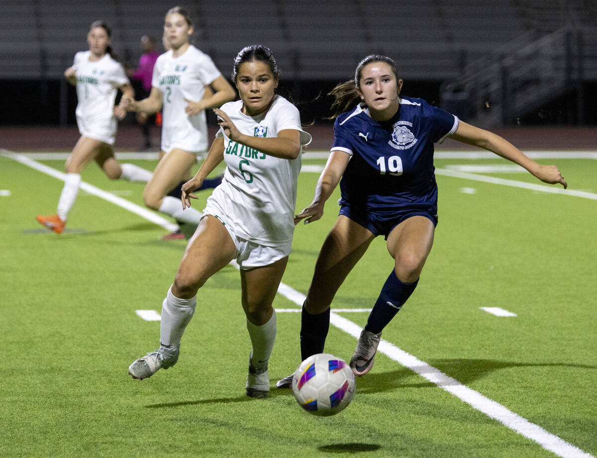 Green Valley junior Shealyn Pease (6) and Centennial midfielder Karly Kramer (19) run for the b ...