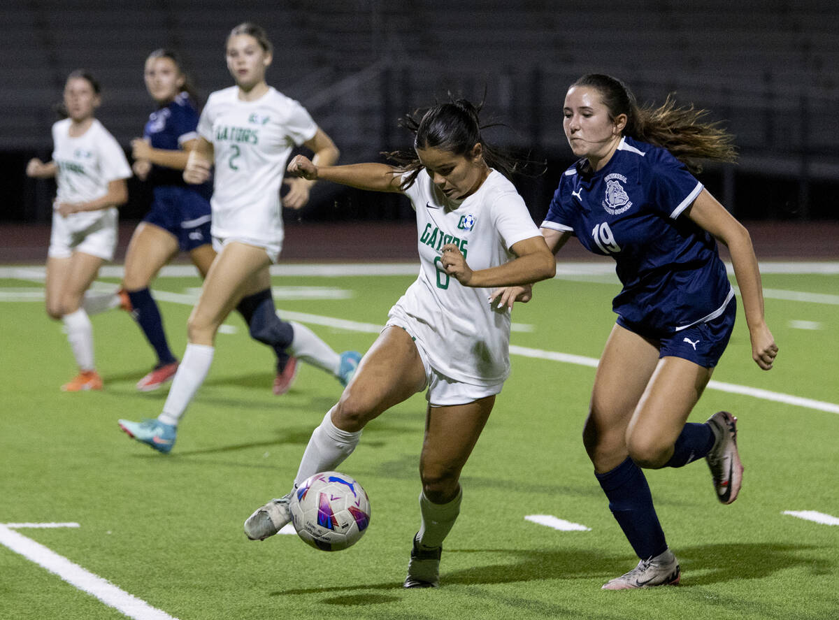 Green Valley junior Shealyn Pease (6) and Centennial midfielder Karly Kramer (19) compete for t ...