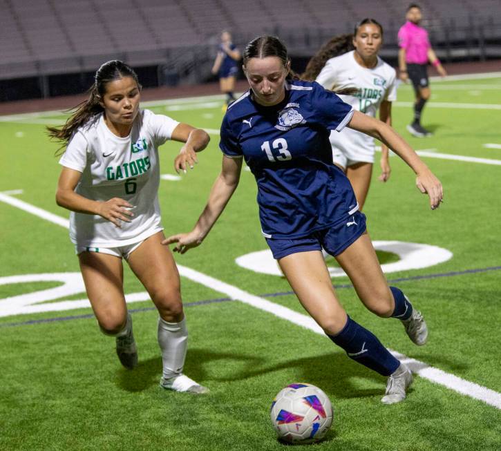 Green Valley junior Shealyn Pease (6) and Centennial defender Ella Davis (13) compete for the b ...