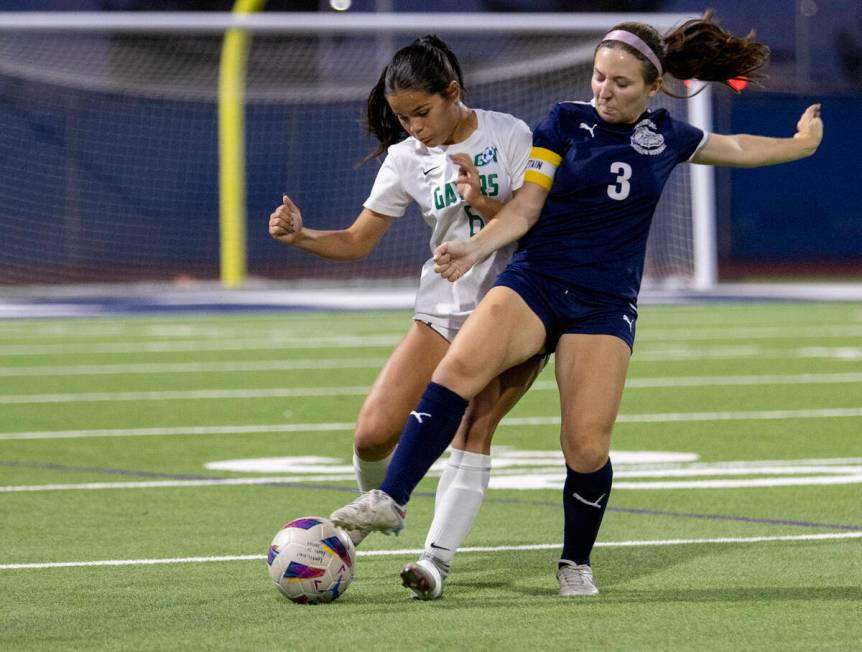 Green Valley junior Shealyn Pease (6) Centennial forward Natalie Sligar (3) compete for the bal ...