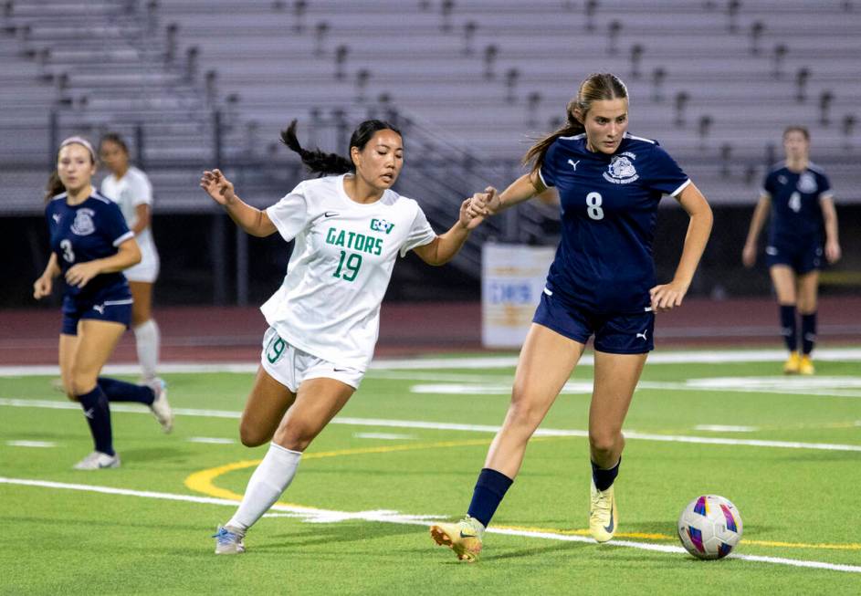 Green Valley midfielder Seira Okui (19) and Centennial forward Claire Orme (8) compete for the ...