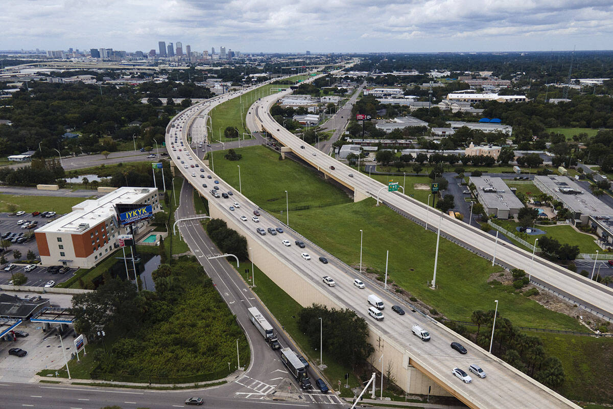 In this image taken with a drone, the Tampa, Fla., skyline, top left, is seen at a distance as ...