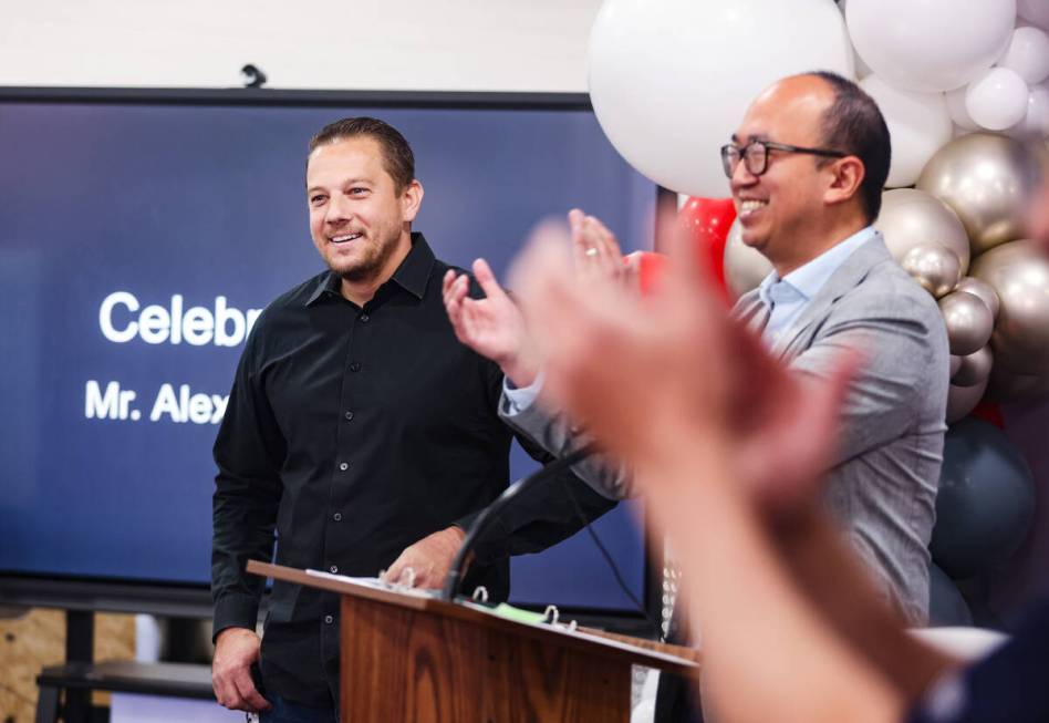 Alex Bechtler, a manufacturing teacher, reacts as everyone applauds at an event honoring him at ...