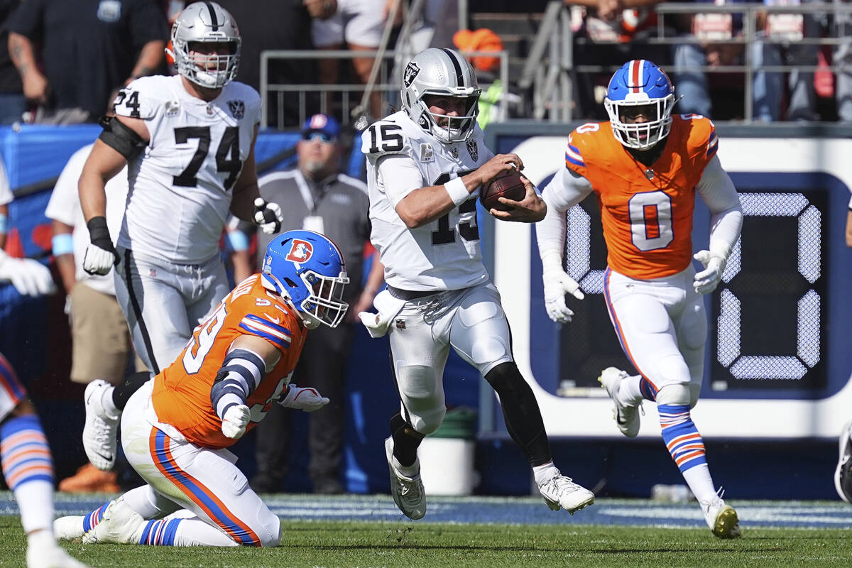 Las Vegas Raiders quarterback Gardner Minshew (15) runs with the ball against the Denver Bronco ...