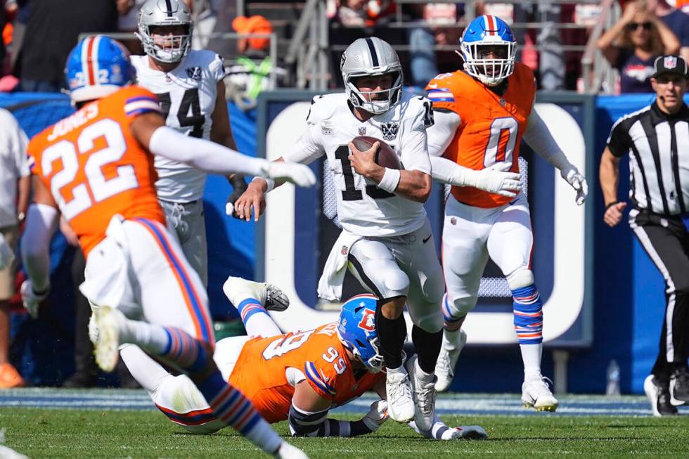 Las Vegas Raiders quarterback Gardner Minshew (15) runs with the ball against the Denver Bronco ...