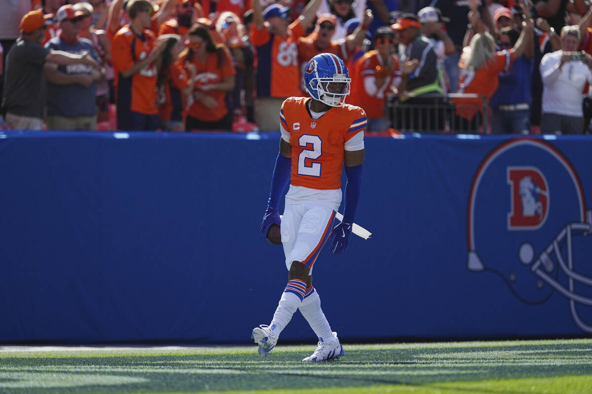 Denver Broncos cornerback Pat Surtain II (2) intercepts a pass for a 100 yard touchdown against ...