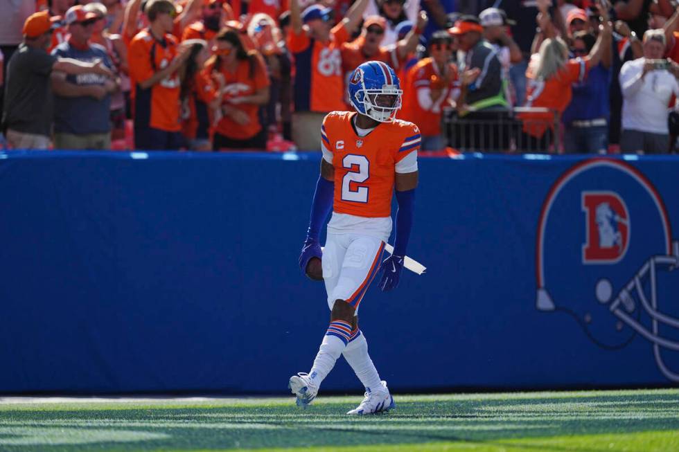 Denver Broncos cornerback Pat Surtain II (2) intercepts a pass for a 100 yard touchdown against ...