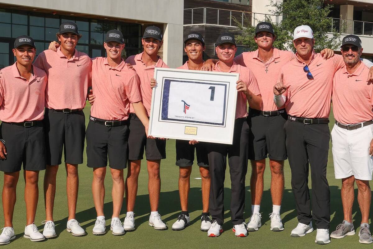 UNLV players and coaches hold the trophy following their win at the Trinity Forest Invitational ...