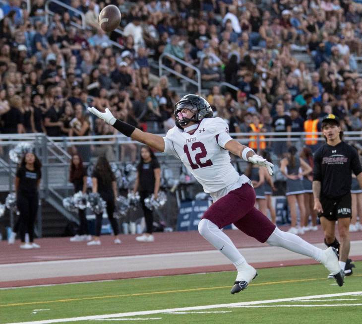 Faith Lutheran junior Aipa Kuloloia (12) dives for a pass that is out of reach during the high ...