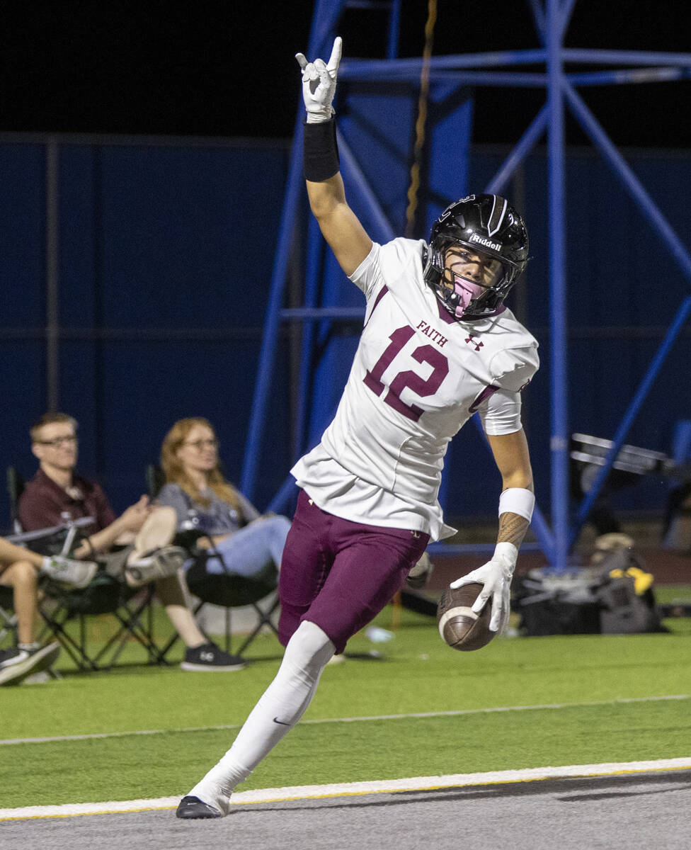 Faith Lutheran junior Aipa Kuloloia (12) celebrates after scoring a touchdown during the high s ...