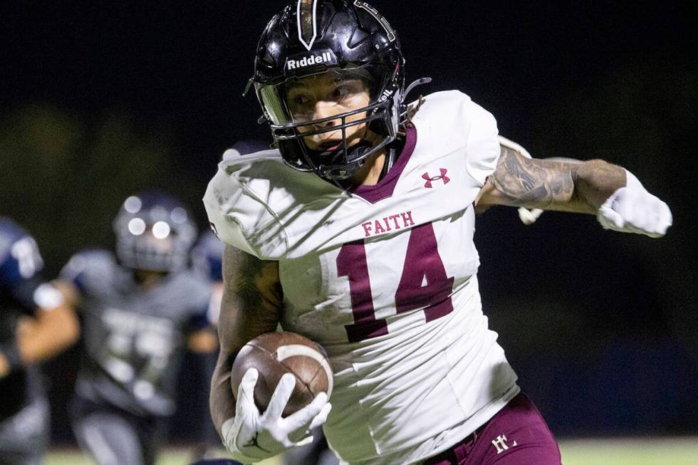 Faith Lutheran senior Cale Breslin (14) runs the ball during the high school football game agai ...