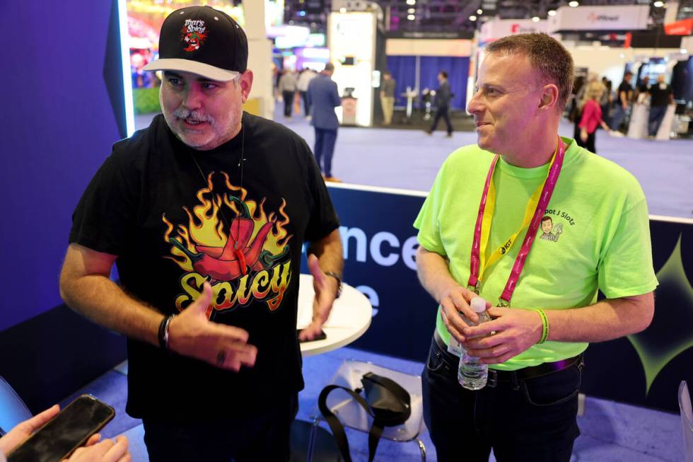 J.J. Feregrino of Uncle J Slots, left, and Jared Scott of Jackpot J Slots talk to a reporter in ...