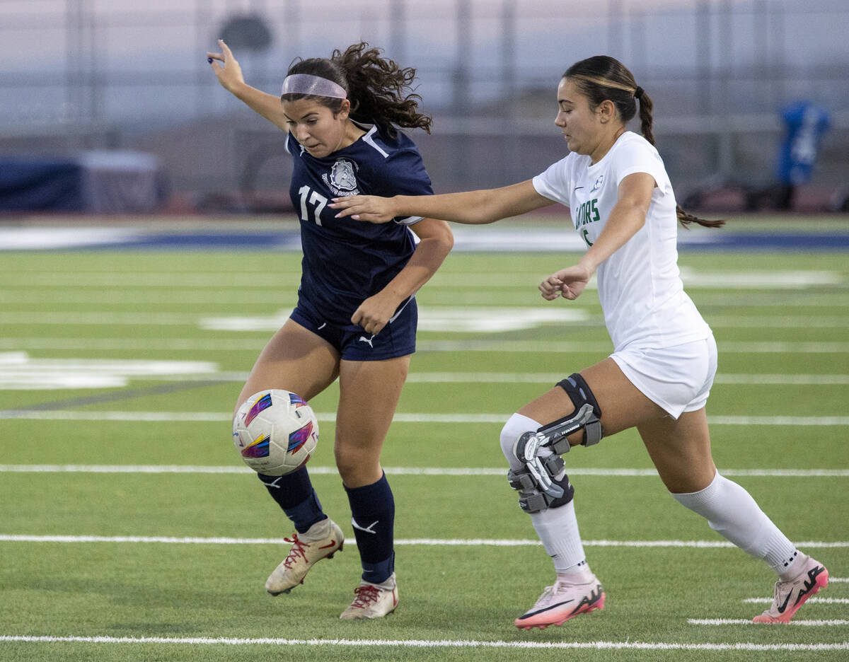 Centennial defender Cameryn Sligar (17) and Green Valley junior Darien Cox (5) compete for the ...