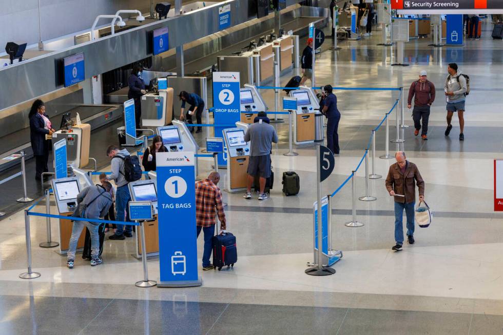 Travelers check in as flights to Tampa, Fla., are canceled due to Hurricane Milton on Wednesday ...