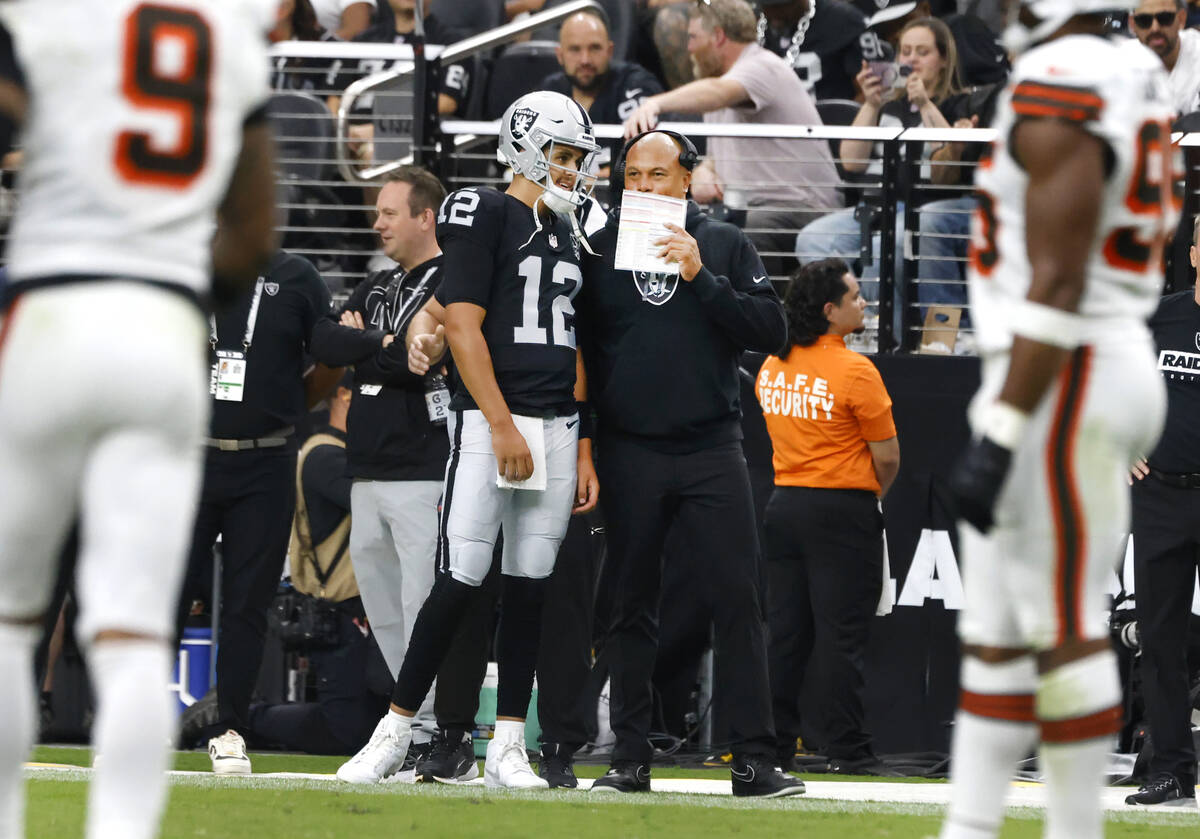 Raiders head coach Antonio Pierce speaks to quarterback Aidan O'Connell (12) on the sidelines d ...