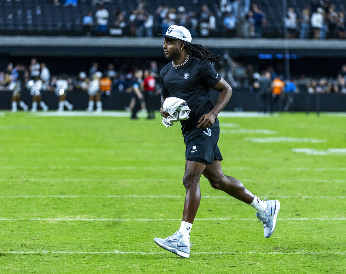 Raiders wide receiver Davante Adams (17) runs to greet fans following their loss to the Dallas ...