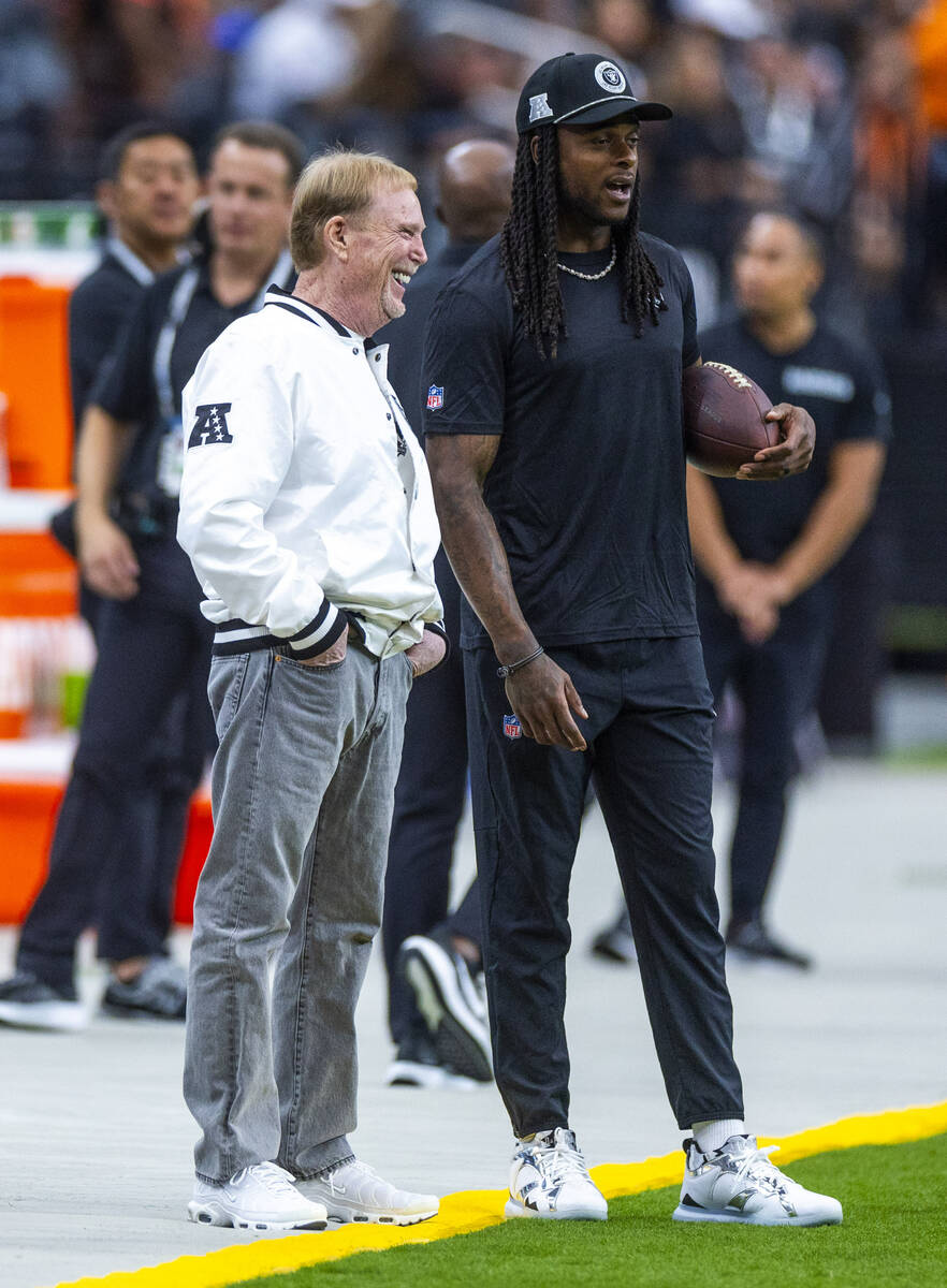 Raiders owner Mark Davis chats with wide receiver Davante Adams (17) during the warm ups of the ...