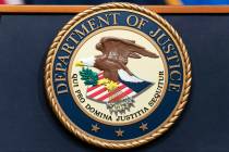 The Department of Justice seal is seen during a news conference at the DOJ office in Washington ...