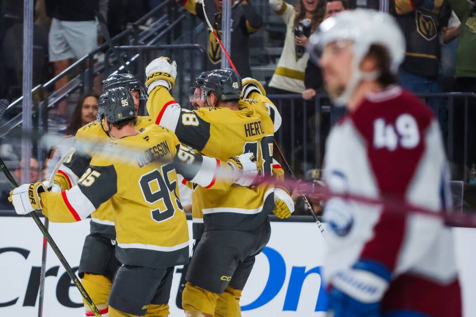 Golden Knights players celebrate a goal as Colorado Avalanche defenseman Samuel Girard (49) ska ...