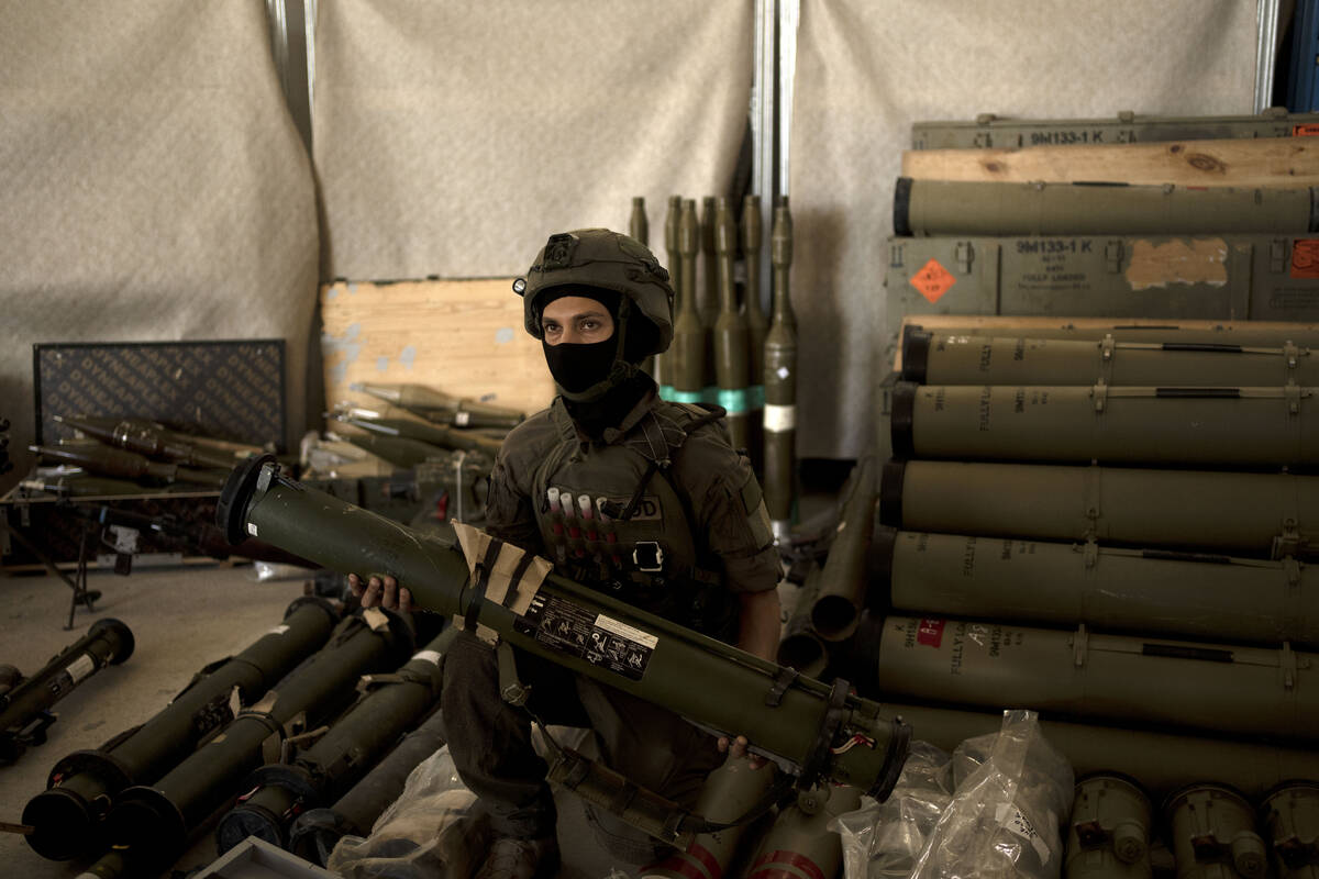 An Israeli soldier from an EOD (explosive ordnance disposal) poses with a weapon used by Hezbol ...