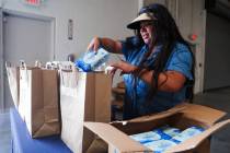 Dolores Maceda, a volunteer, packs diapers and wipes into bags during a Diapers for Diplomas di ...