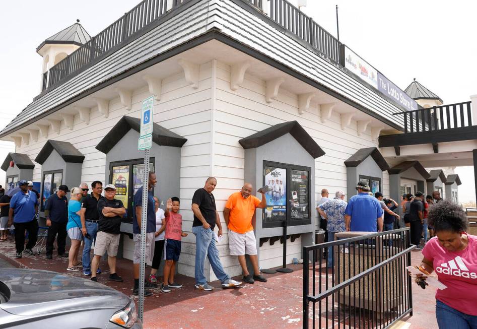 People line up outside of the Primm Valley Lotto Store to buy the Mega Million lottery tickets, ...