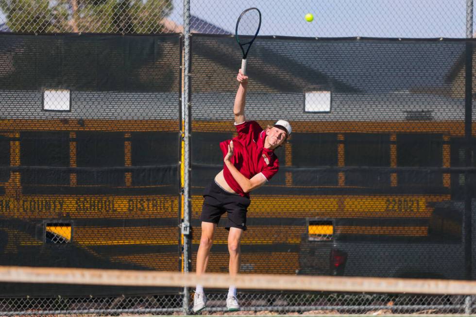 Faith Lutheran’s Sam Fouse slams the ball over the net during a 5A high school boys tenn ...