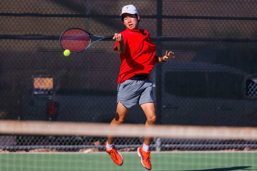 Coronado’s Grant Lee hits the ball with his racquet during a 5A high school boys tennis ...