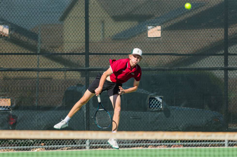 Faith Lutheran’s Sam Fouse slams the ball over the net during a 5A high school boys tenn ...