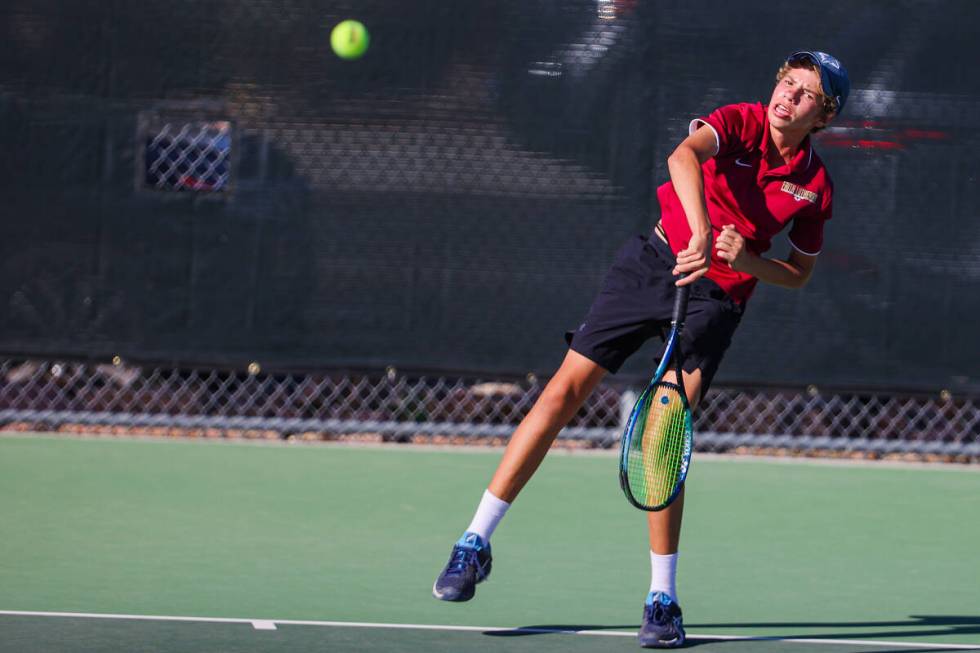 Faith Lutheran’s Dennis Oxenuk hits the ball with his racquet during a 5A high school boys te ...