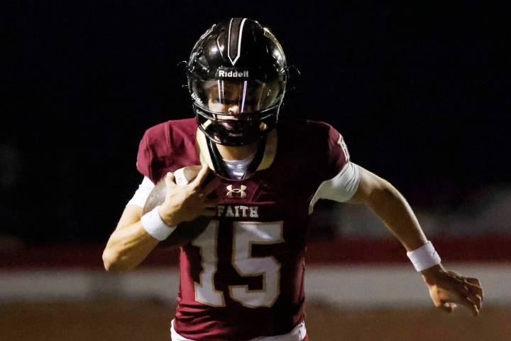 Faith Lutheran's quarterback Alexander Rogers (15) runs for a touchdown during the first half o ...