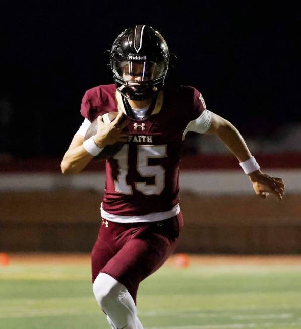 Faith Lutheran's quarterback Alexander Rogers (15) runs for a touchdown during the first half o ...