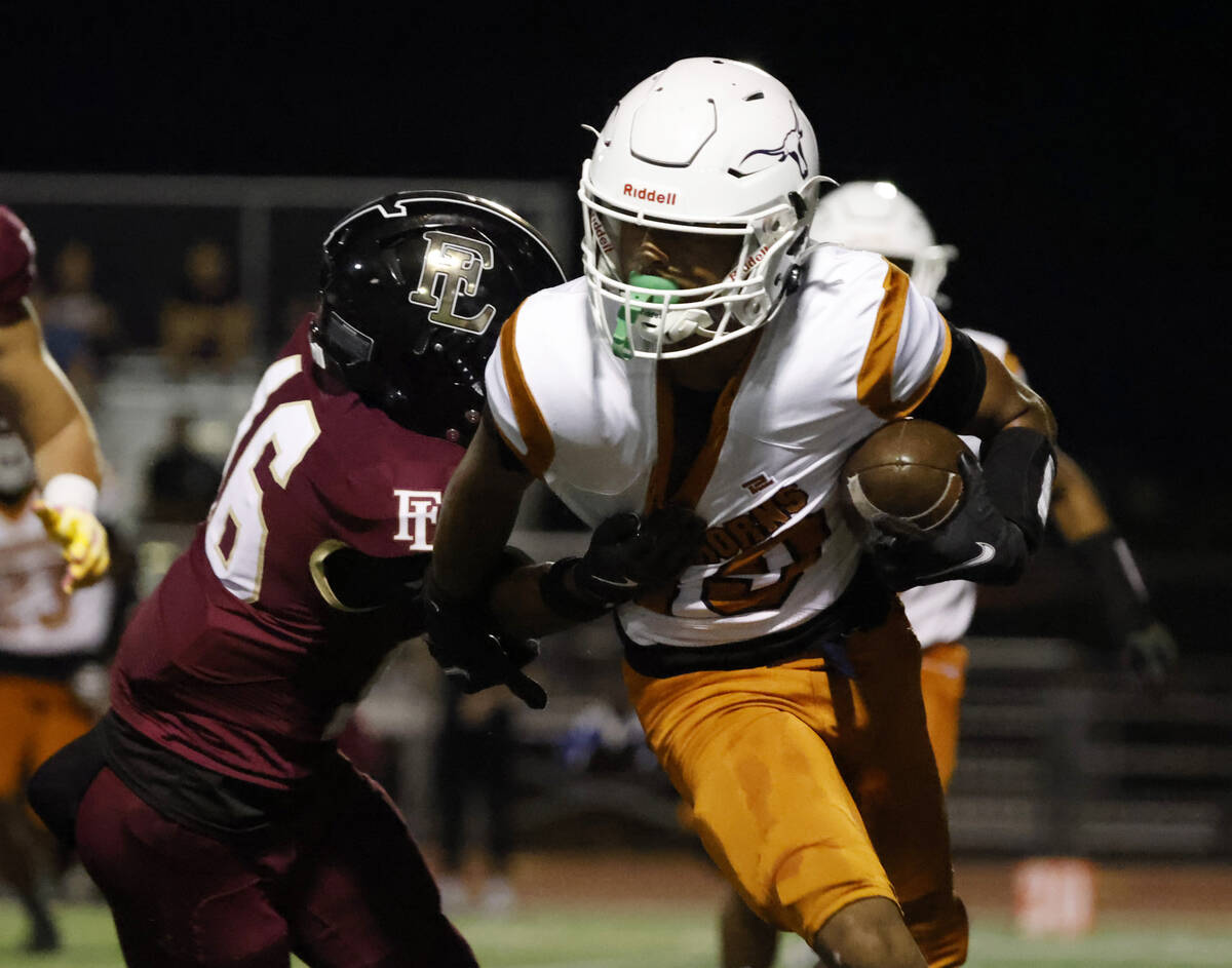 Legacy High's wide receiver Dejuan Robinson (19) runs past Faith Lutheran's defensive back Trey ...