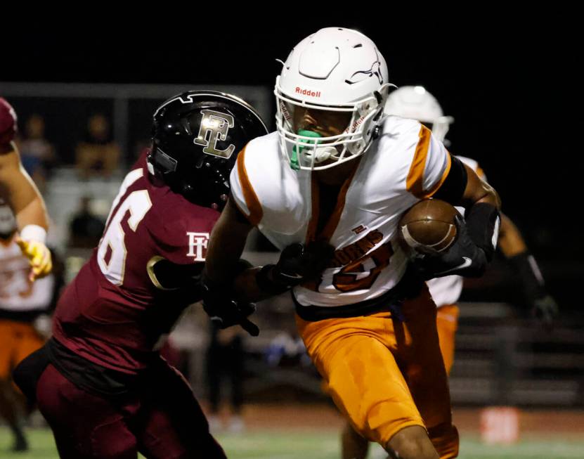 Legacy High's wide receiver Dejuan Robinson (19) runs past Faith Lutheran's defensive back Trey ...