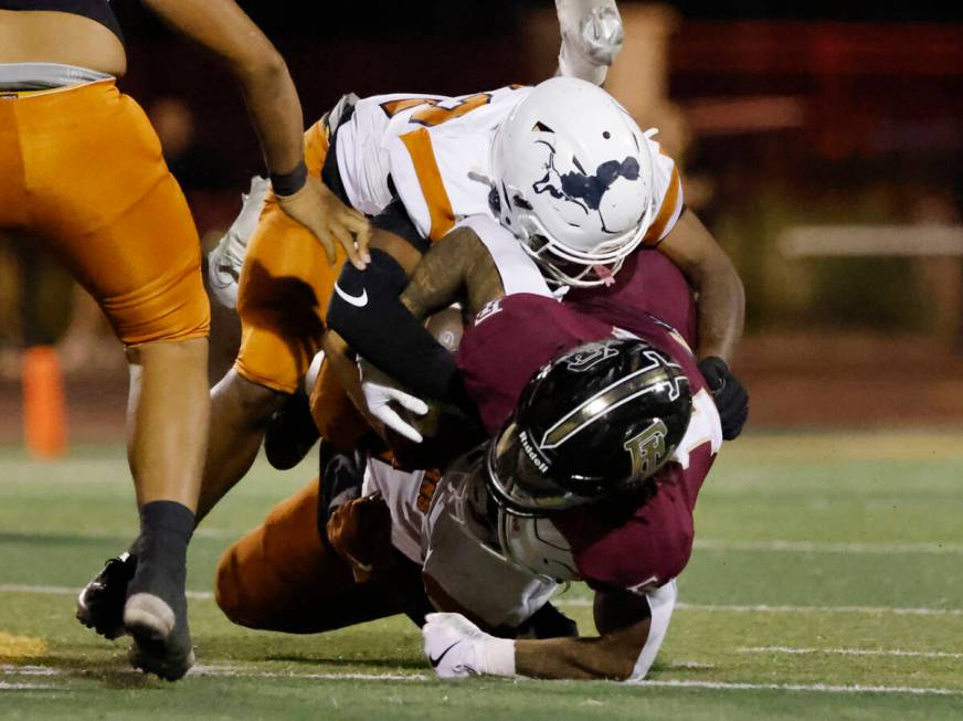 Legacy High's linebacker Martell Mckenzie (22) takes down Faith Lutheran's Cale Breslin (14) du ...