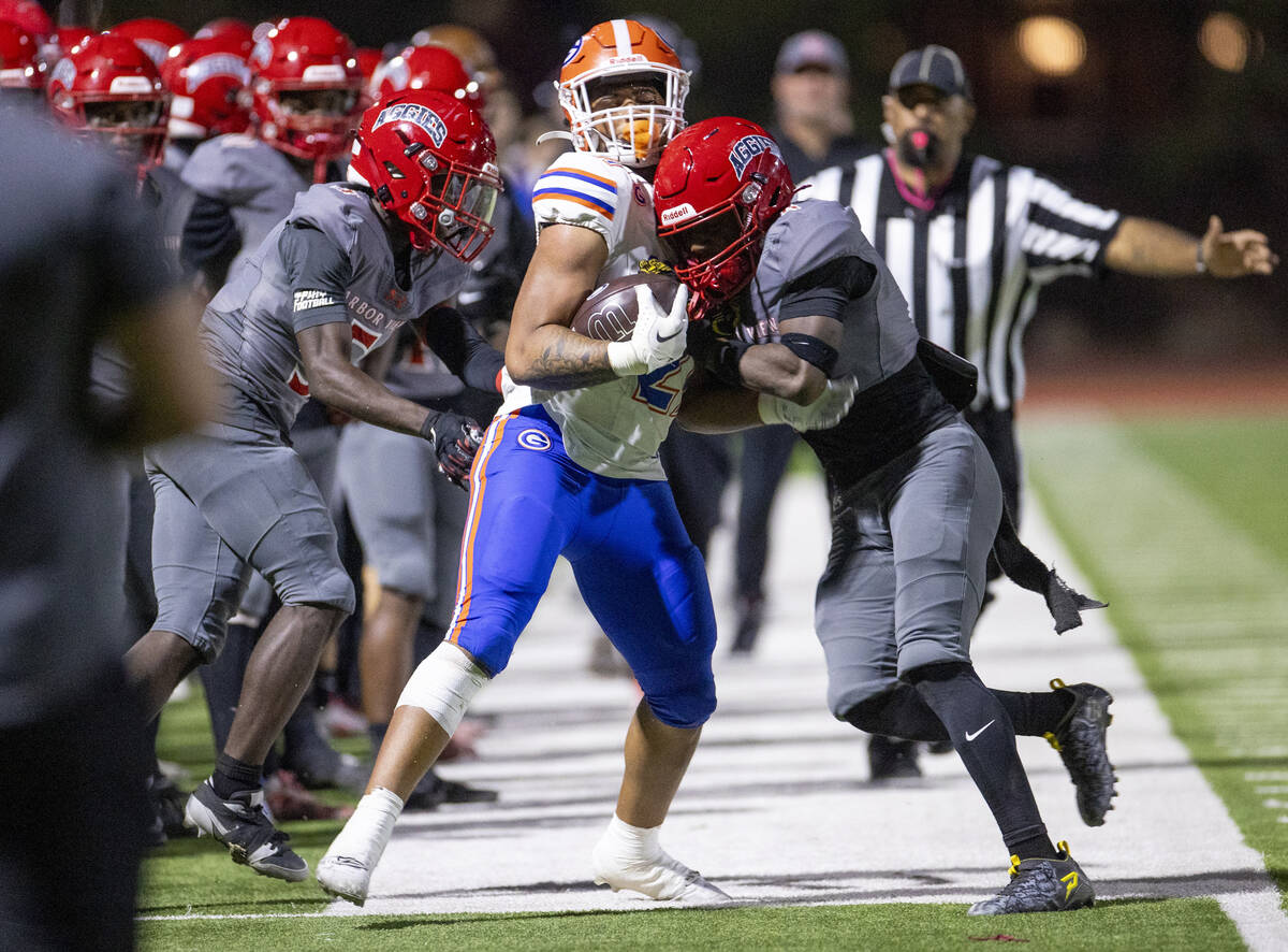 Arbor View senior Kent Bell III (8) delivers a late hit on Bishop Gorman running back Jonathan ...