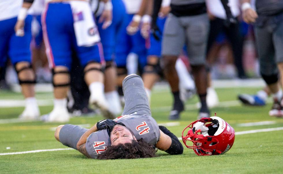 Arbor View linebacker Christian Thatcher (42) grabs his chest after a hard hit during the high ...