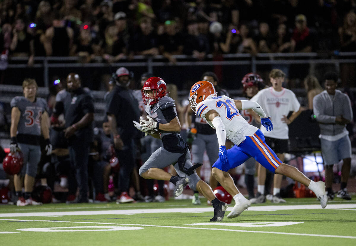 Bishop Gorman defensive back Alexander Perez (20) looks to tackle Arbor View wide receiver Kai ...