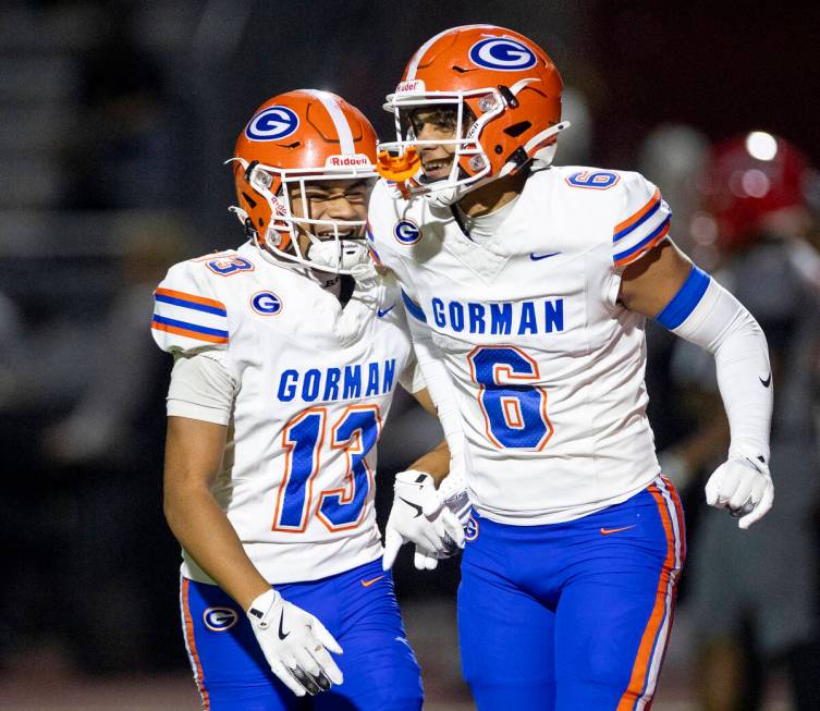 Bishop Gorman wide receiver Aizen Torres (13) and wide receiver Brandon Gaea (6) celebrate a pl ...