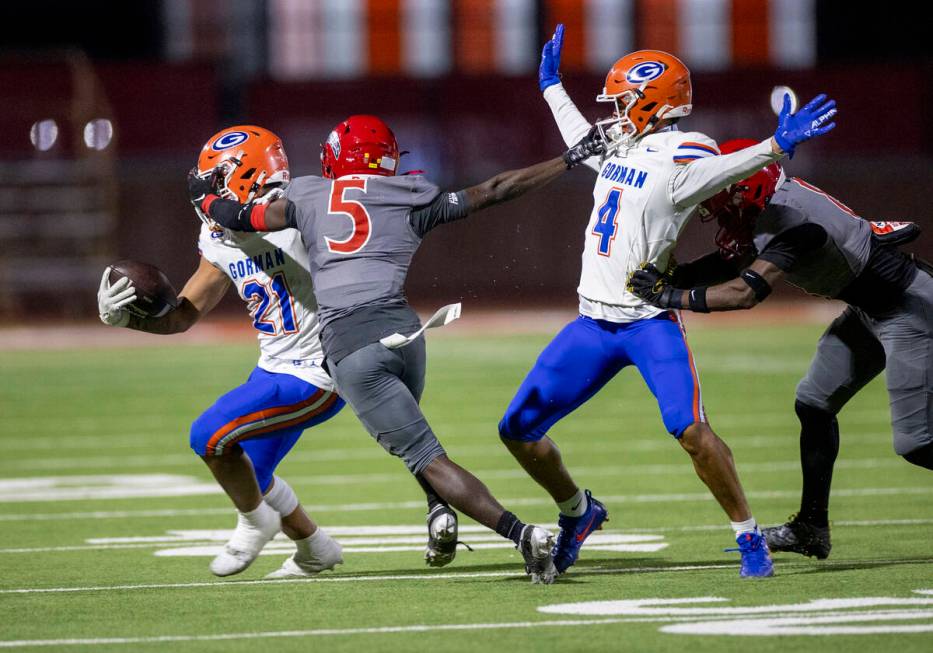 Arbor View cornerback Teddy Johnson (5) attempts to tackle Bishop Gorman running back Jonathan ...