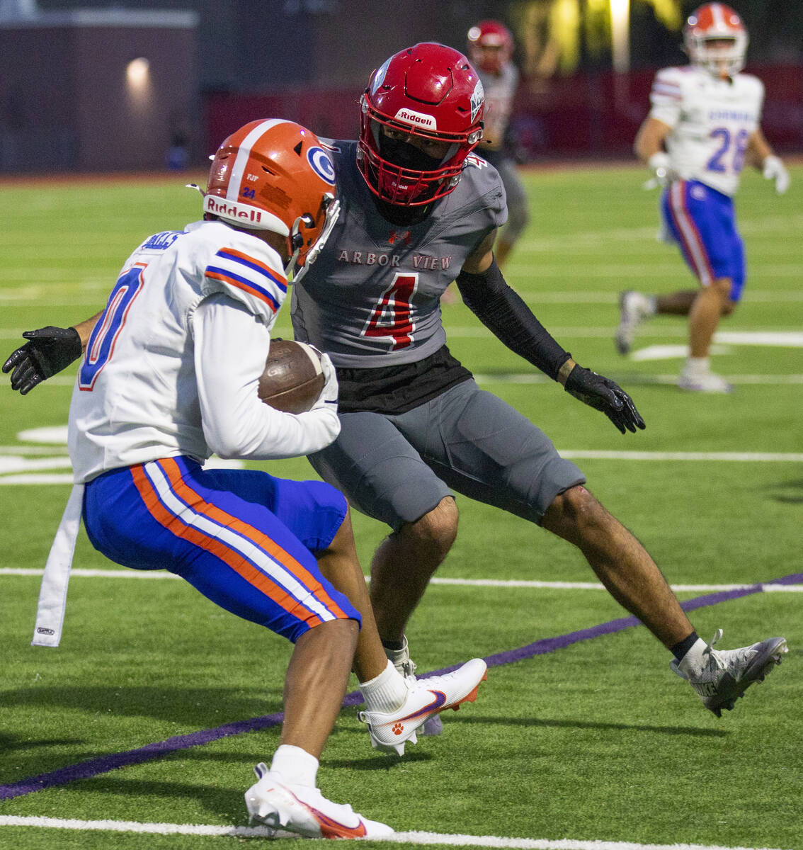 Arbor View senior Tico Pringle (4) looks to tackle Bishop Gorman defensive back Isaiah Nickels ...