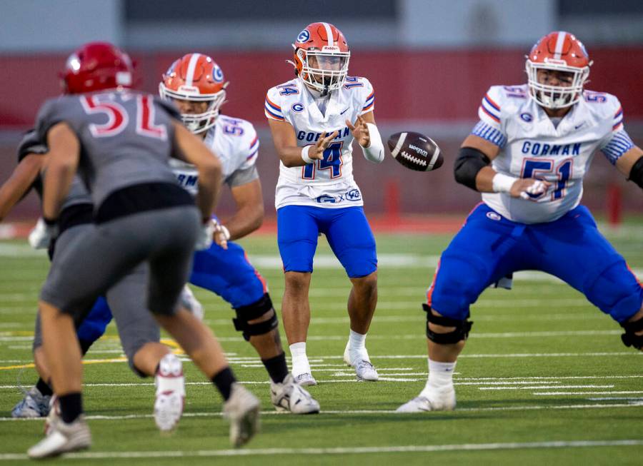 Bishop Gorman quarterback Maika Eugenio (14) snaps the ball during the high school football gam ...