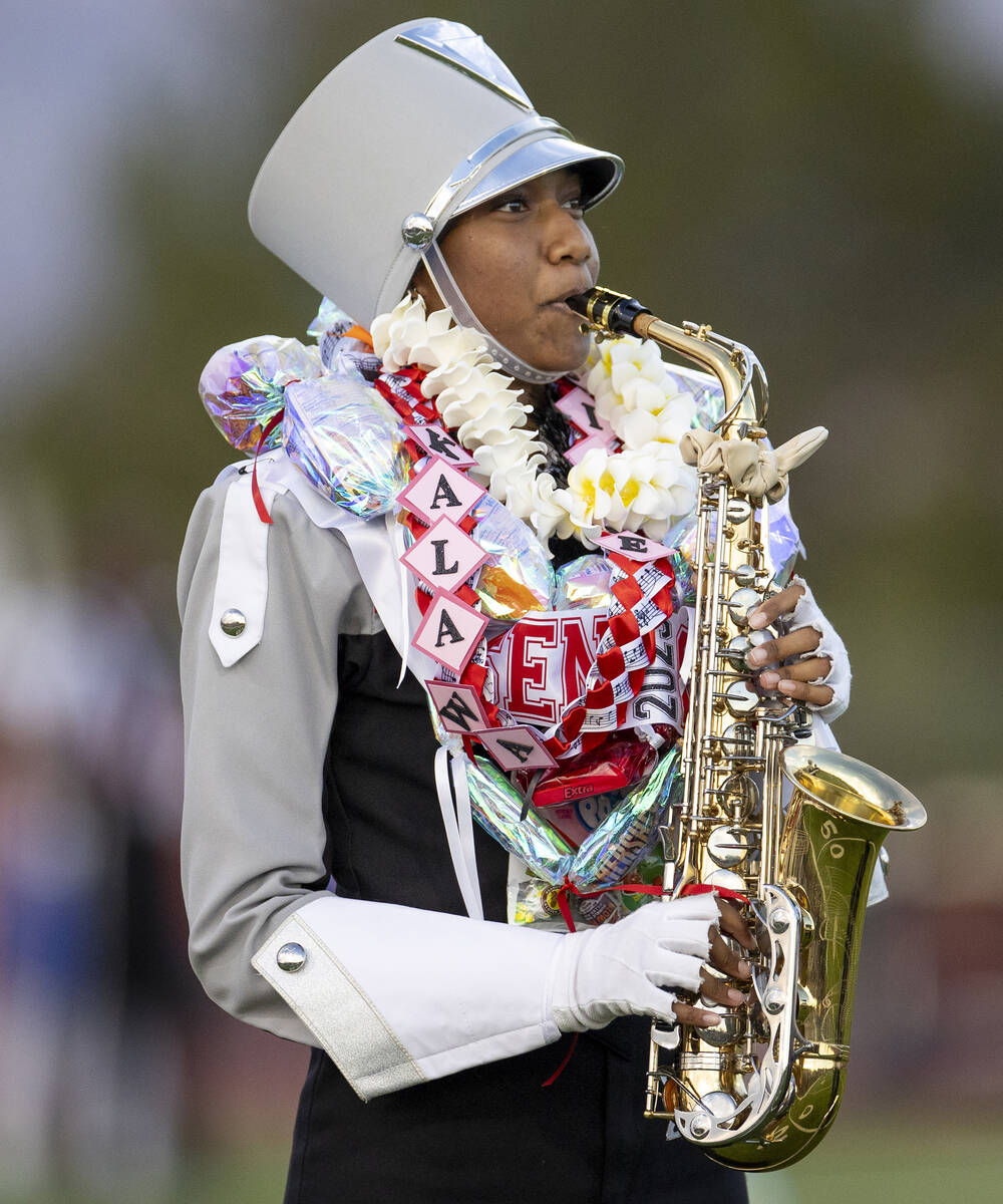 A member of the Arbor View Marching Band performs before the high school football game between ...