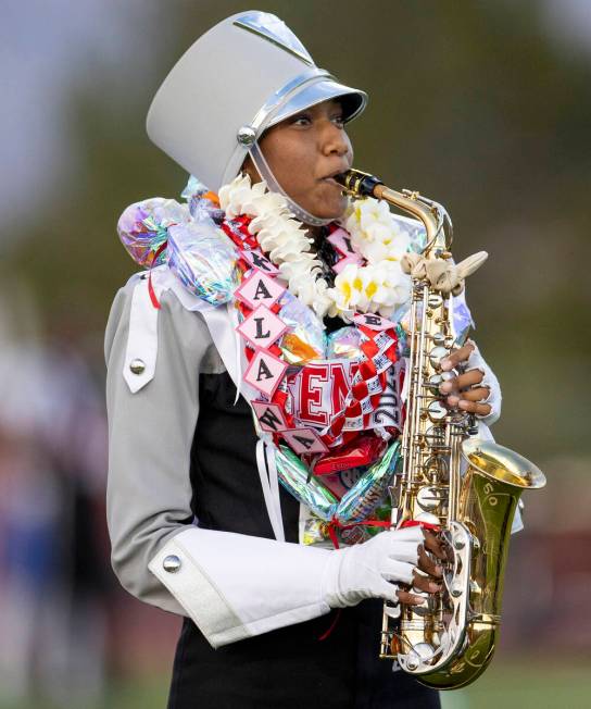 A member of the Arbor View Marching Band performs before the high school football game between ...