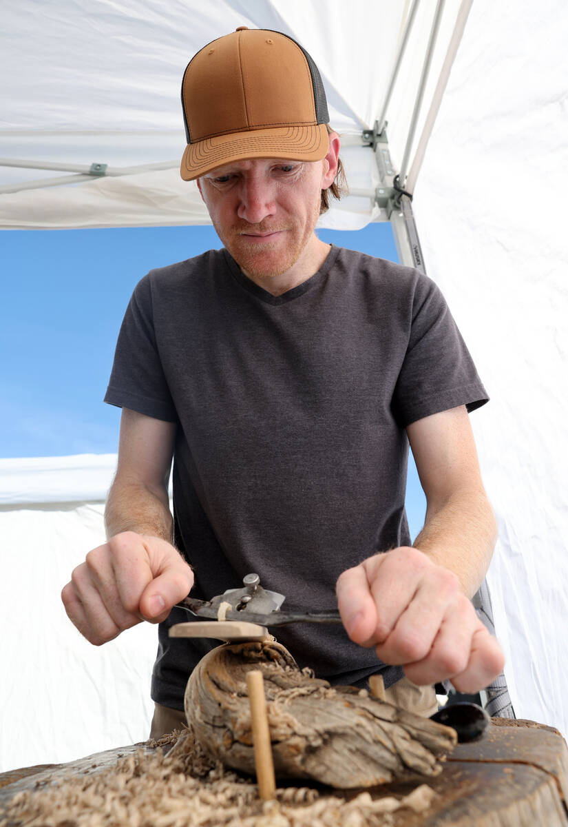 Austin Anderson of Fremont, Utah works on his wood crafts art during Summerlin Festival of Arts ...