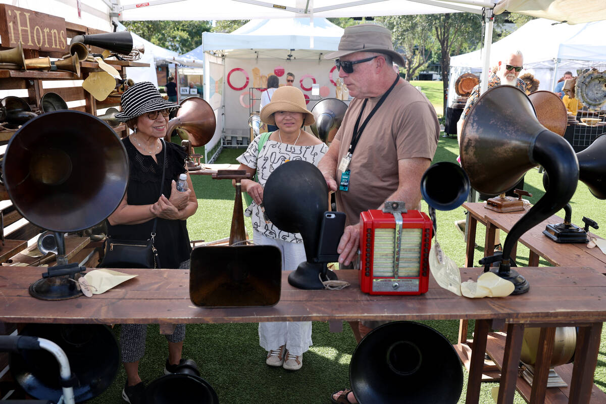 Frank Falk of Salt Lake City shows his mixed-media art that can play music from a phone during ...