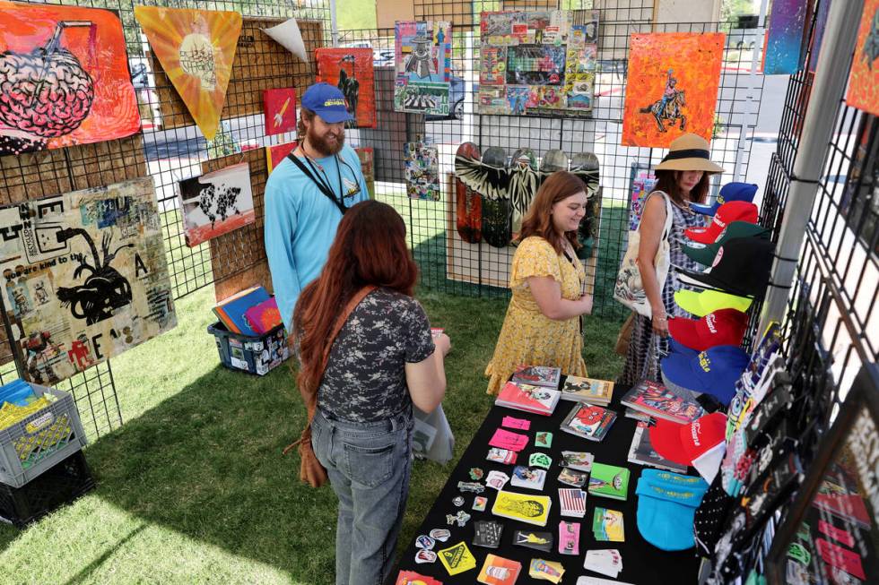 Izaac Zevalking of Recycled Propaganda in Las Vegas mingles with customers during Summerlin Fes ...