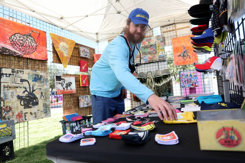 Izaac Zevalking of Recycled Propaganda in Las Vegas organizes his artist booth during Summerlin ...