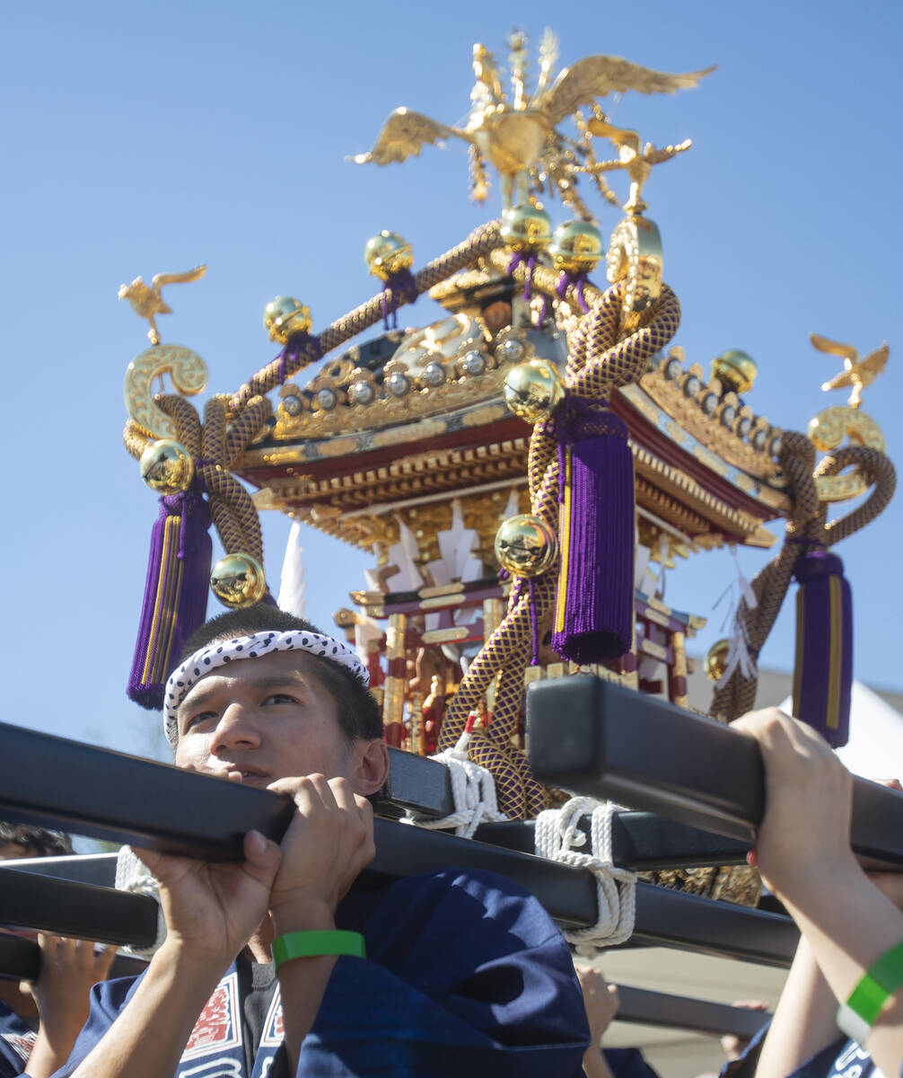 People carry a Mikoshi during the Aki Matsuri Japanese Festival at Water Street Plaza, Saturday ...