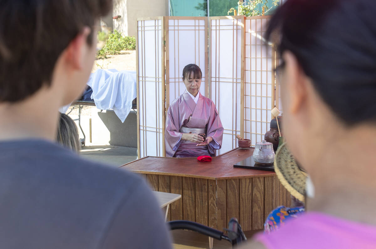 Festivalgoers watch a tea demonstration during the Aki Matsuri Japanese Festival at Water Stree ...